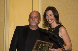 Betsy Kling receives the Chuck Heaton Award plaque from Michael Heaton.