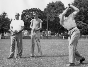 Three men playing golf.